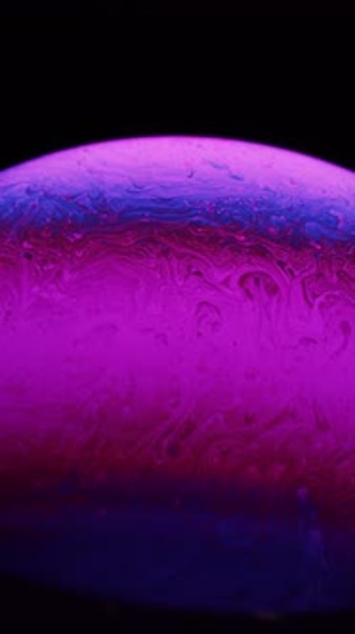 Soap Bubble With Magenta And Blue Fluid Motion