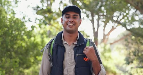 Smile, face or man hiking in nature, park or woods for vacation, break or holiday adventure