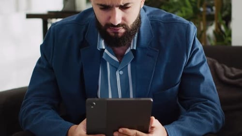 Adult Using Tablet Smiling Indoors