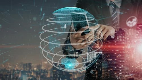 Businessman with smartphone in front of digital globe and city skyline showing technology, connectiv