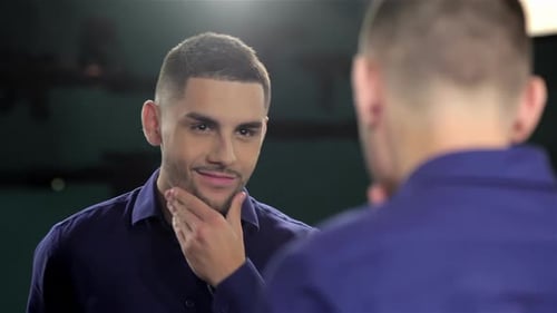 Man Checks Appearance in the Mirror