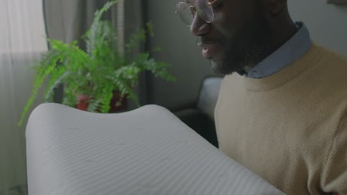 Black Man Thanking Doctor for Orthopedic Pillow in Sleep Clinic
