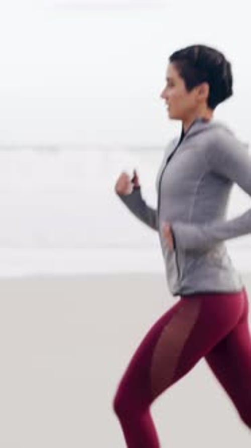Fitness, health and running with woman on beach in morning for cardio improvement or training