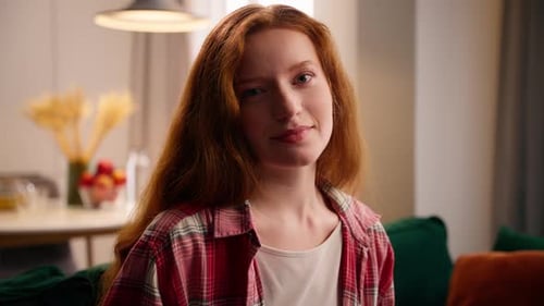 Attractive Young Woman Smiles in Casual Indoor Portrait