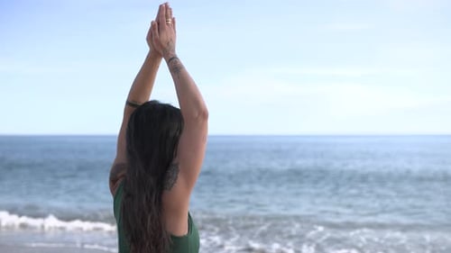 Woman Practicing Yoga on Beach with Ocean View