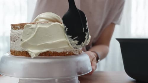 Applying Frosting to Layer Cake with Spatula