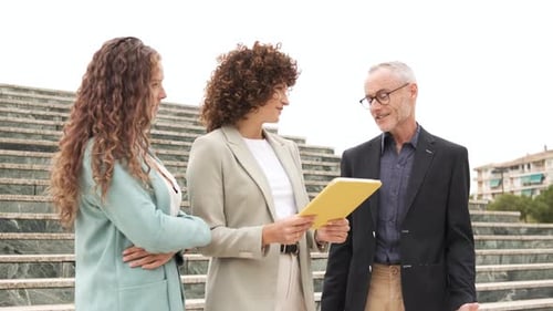 Businesspeople Meeting and Talking on Urban Staircase