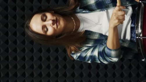 Drummer playing drums at rehearsal recording studio. Vertical video