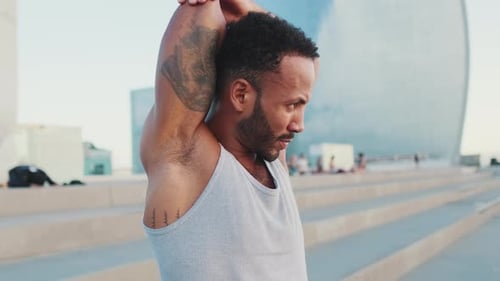 Man Stretches Arm in the City