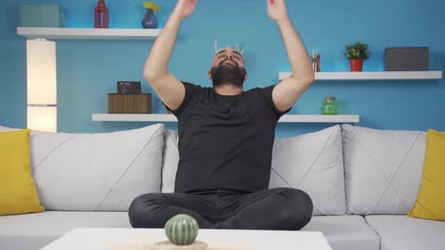 Man Doing Yoga On A Couch Indoors