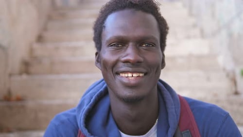 Smiling Young Man Wearing Blue Hoodie Close Up