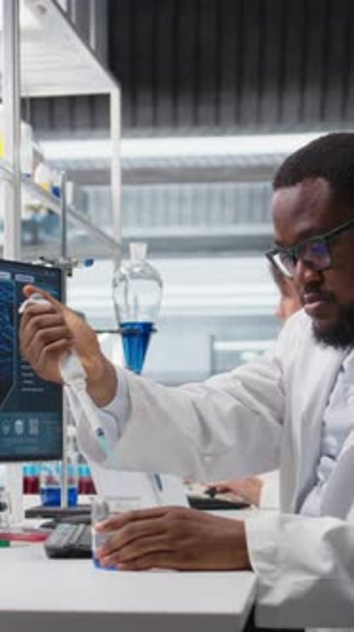 Scientists Work in Modern Lab, Pipette and Beaker
