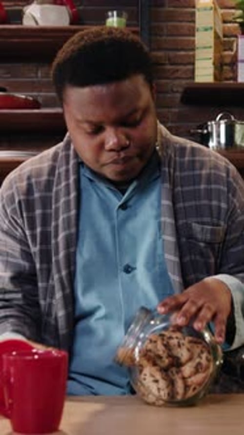 Young Adult Enjoying Chocolate Chip Cookie