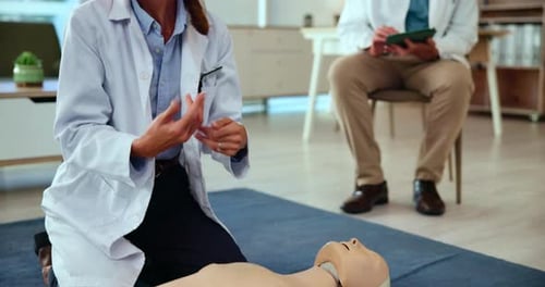 CPR training, teaching or doctor with dummy for first aid instructions, life saving technique