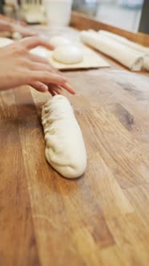 Shaping the Bread with the Dough in the Bakery the Baker Proceeds