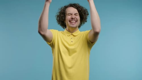 Excited Man Celebrates Success in Studio