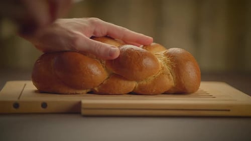 Cutting Slices of Braided Bread with Knife
