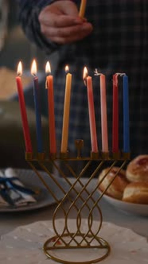 Lighting Hanukkah Candles on a Menorah at Home
