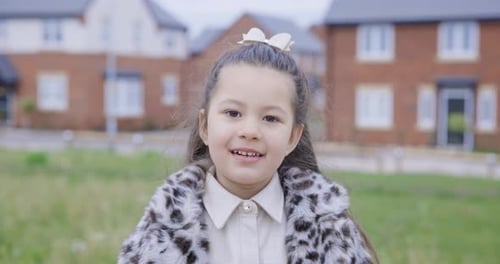 Authentic mixed race smiling girl portrait at park