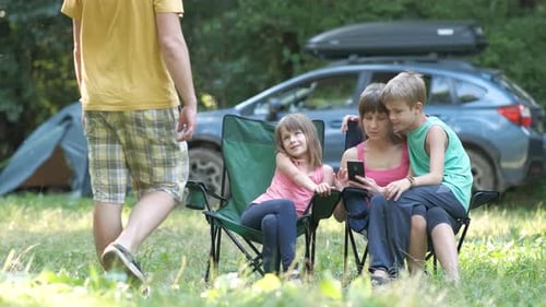 Family Relaxing Together While Camping in Nature