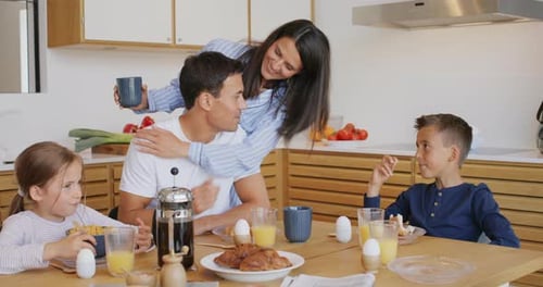Family Enjoying Breakfast Together in a Bright Kitchen