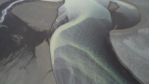 Aerial view of a water abstract pattern from a river estuary in Iceland.