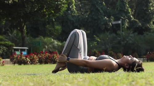 Video clip of an Indian woman practicing shoulder-supported bridge, also known as bridge exercise.