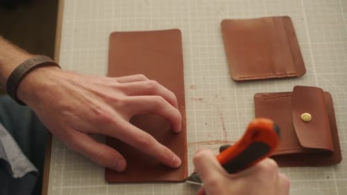 Leather Craftsman Works in His Workshop Master Making Leather Wallet Man Cleans Up Leather Edge with