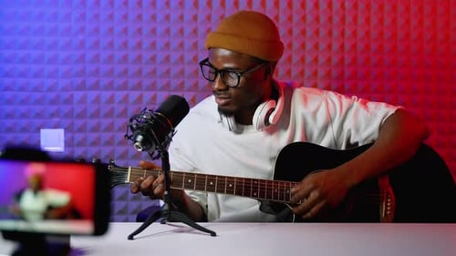 Guitar Player Performing in Recording Studio at Home