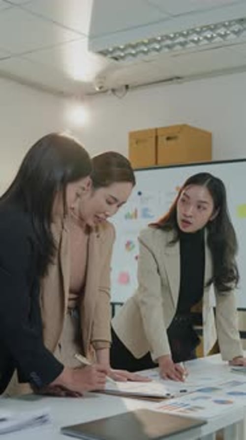 Team Collaborates Around a Table in an Office