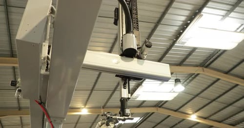 Articulated Robotic Arm Transporting Ejected Plastic Product From Injection Molding Machinery. low a