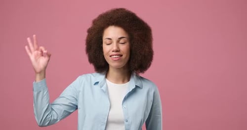 Woman Smiling and Gesturing Okay Sign