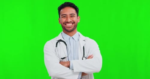 Healthcare, green screen and a doctor man arms crossed on a studio background for treatment