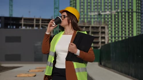Female Construction Engineer with Coffee and Laptop