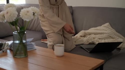 Woman Works on Laptop While Sitting on Couch
