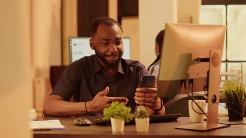 Man Video Calling on Phone in Modern Office