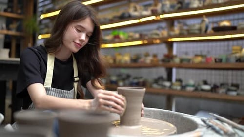 People Creating Pottery in Studio. Female artisan creating handmade ceramics in pottery workshop