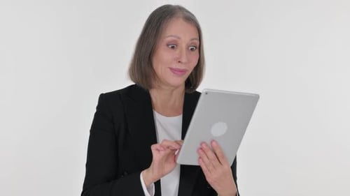 Excited Mature Woman Using a Tablet