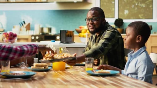 Family Enjoying Breakfast Together in Sunny Kitchen
