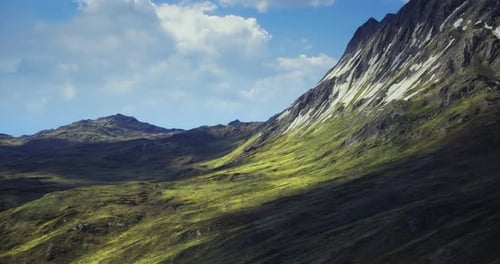Flying Over Lush Green Mountains Under Blue Sky