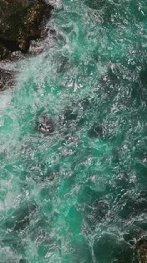 American ocean with rocky coastline. Aerial view of rocky ocean landscapes. Vertical video