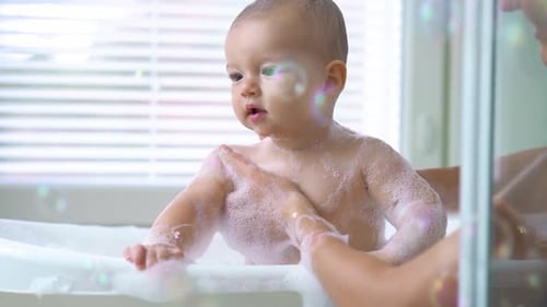 Baby Enjoying Bath Time with Bubbles and Sunlight