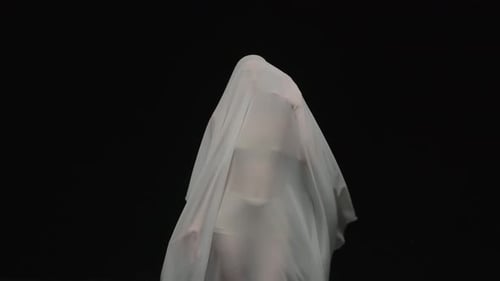 Ghostly Figure Turning Slowly in White Sheet