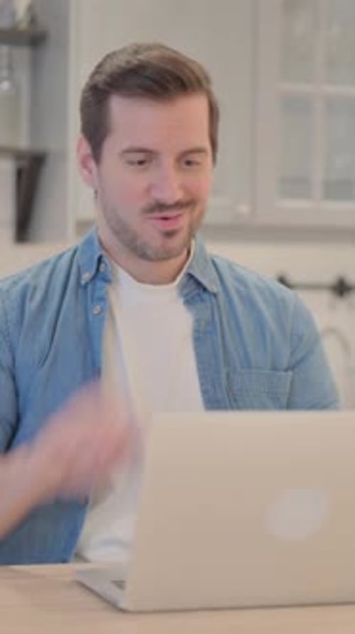 Man on Laptop Talking During Video Call at Home