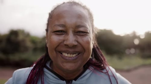 Smiling Woman in Blue Hoodie Outdoors