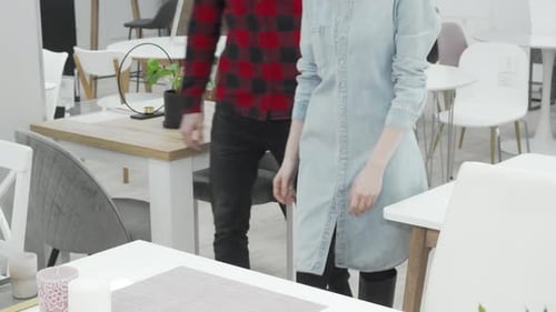 Joyful Couple Exploring Stylish Furniture Options at a Vibrant Department Store