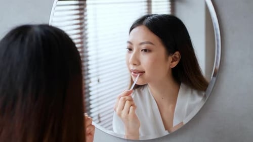 Young Woman Enjoying Her Selfcare Routine in a Modern Home Bathroom