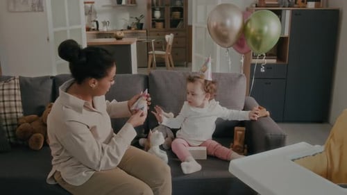 Mother and Baby Taking Selfie at Birthday Party