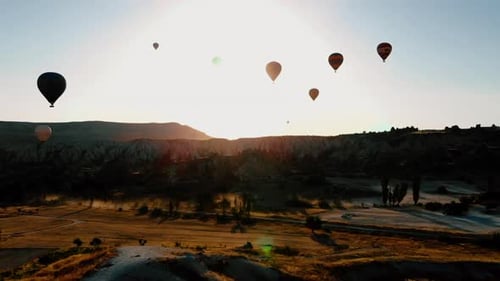 HOT AIR BALLOONS ARE TRAVELING IN VALLEY
