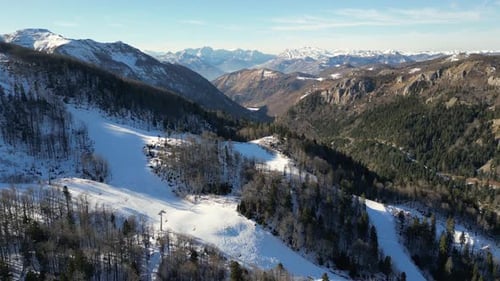 Snowy Winter Mountains Covered with Forests Aerial View